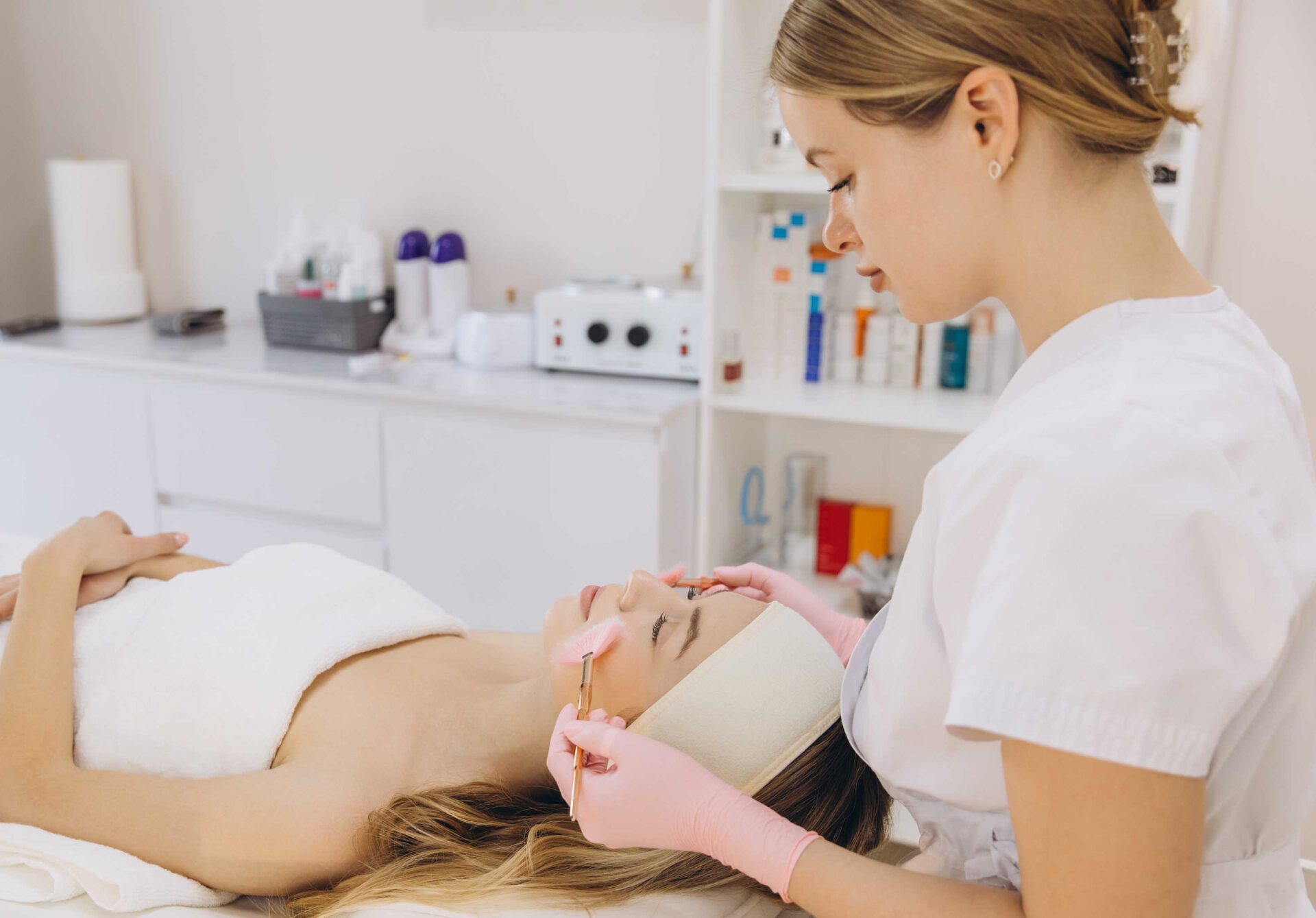 Professional beautician performing a facial treatment on a client in a spa or beauty salon
