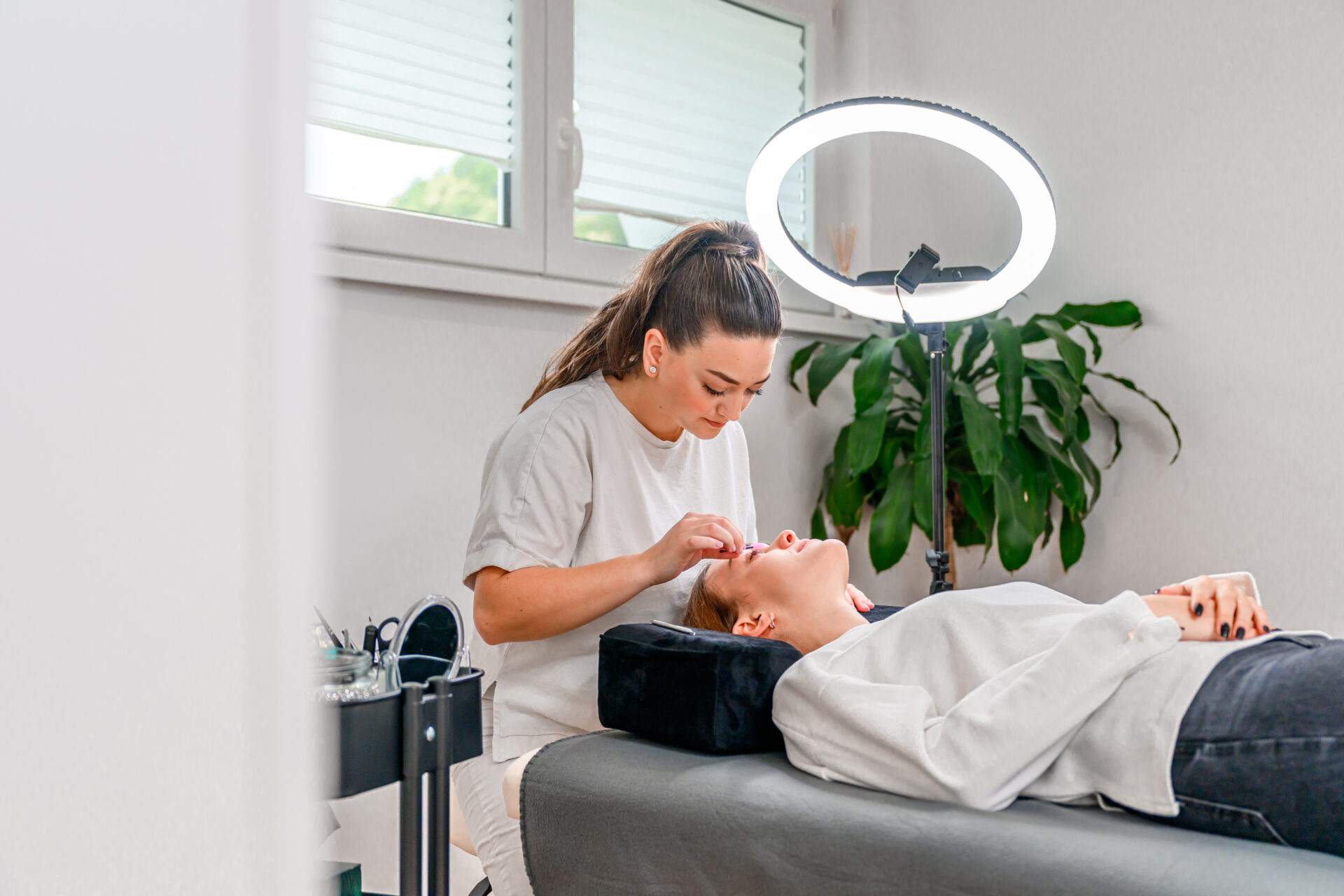 Beauty therapist taking care of a clinet's brows and lashes